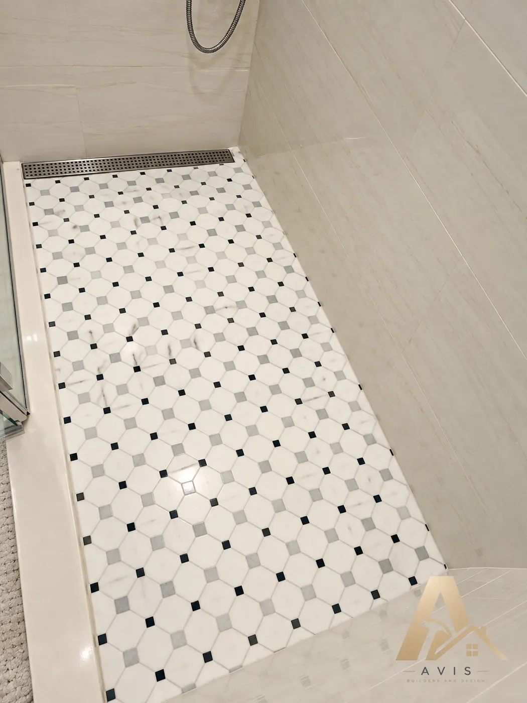 White and gray mosaic shower floor tile with a linear drain