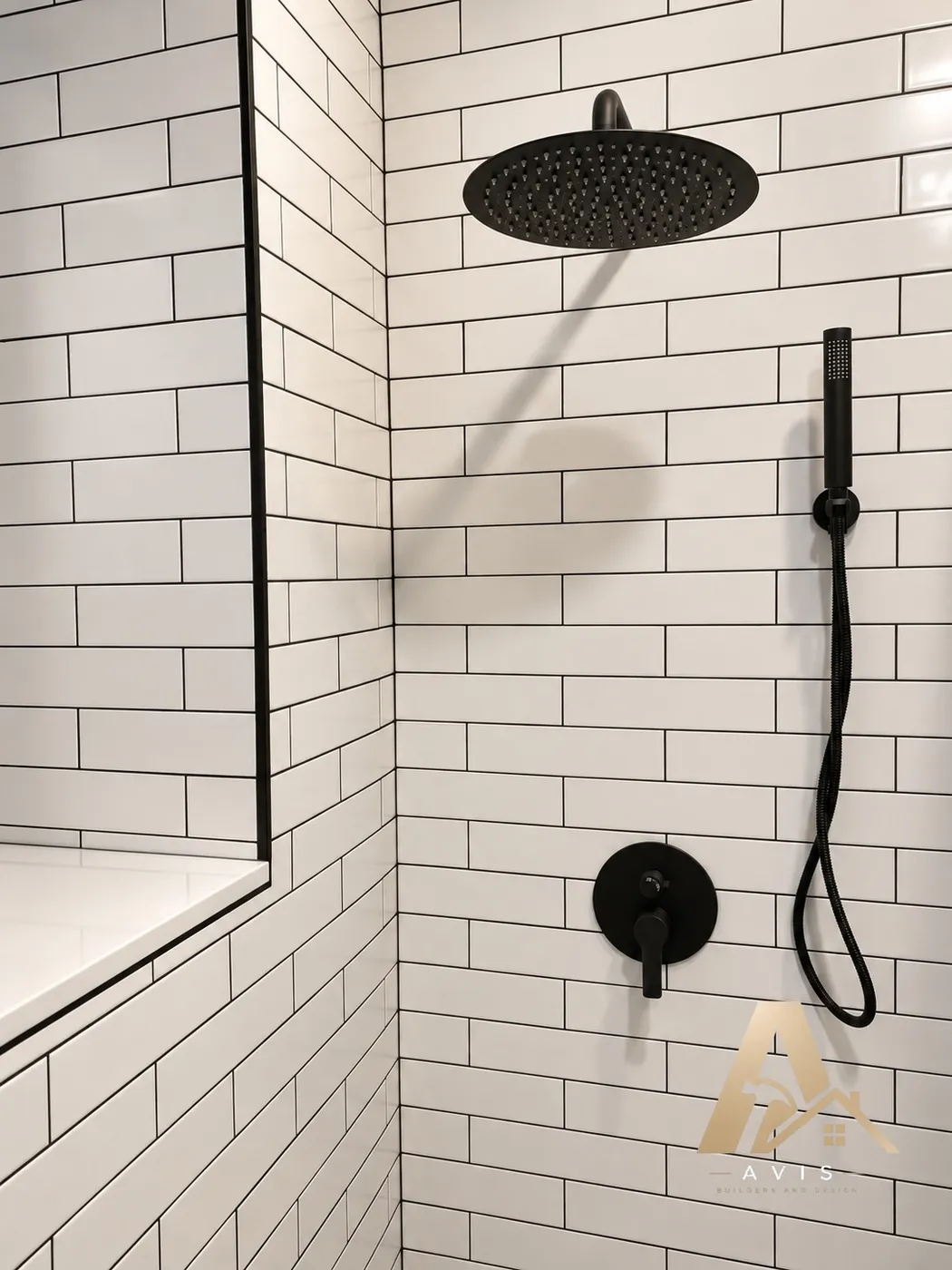 Matte black rain shower head, handheld shower, and valve on white tile
