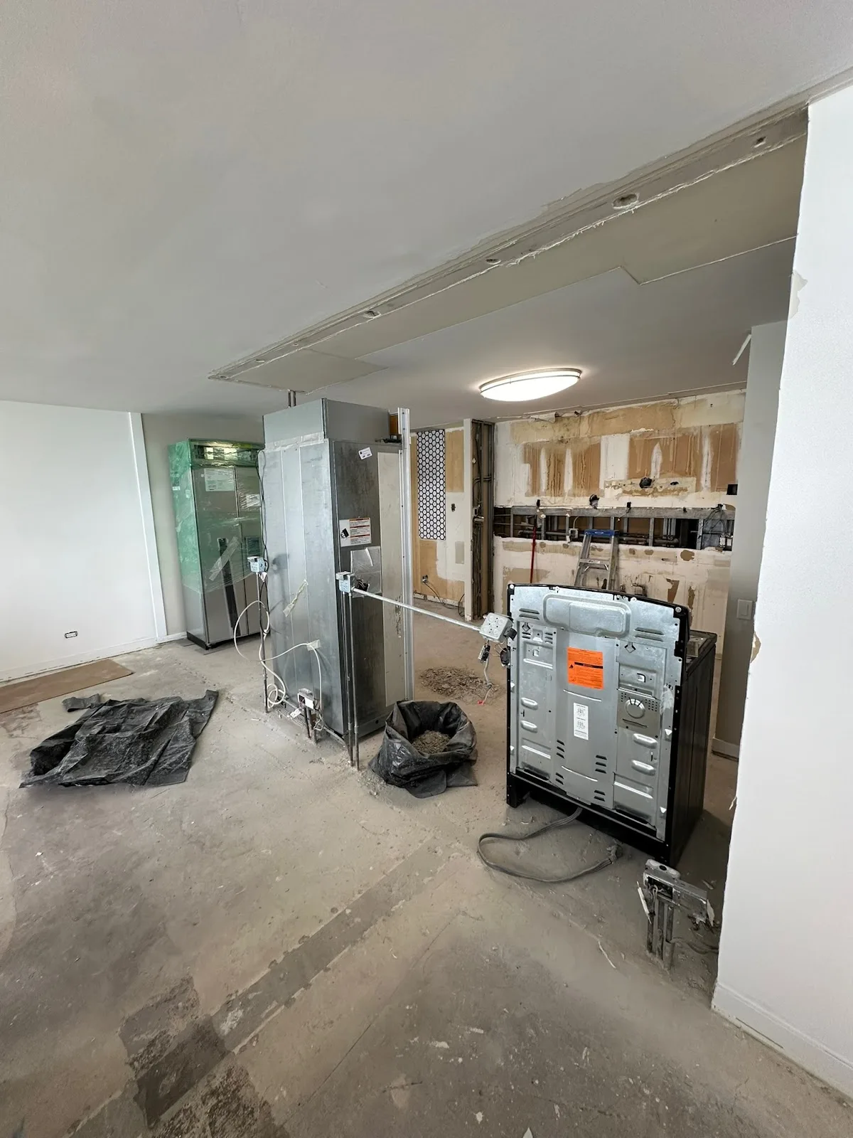 Interior stripped back to bare concrete and framing during a whole-home remodel